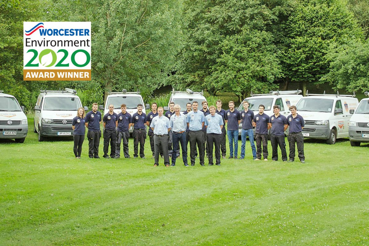 Lewington Heating team and service vans on a grassy field, displaying their Worcester Environment 2020 Award Winner badge.
