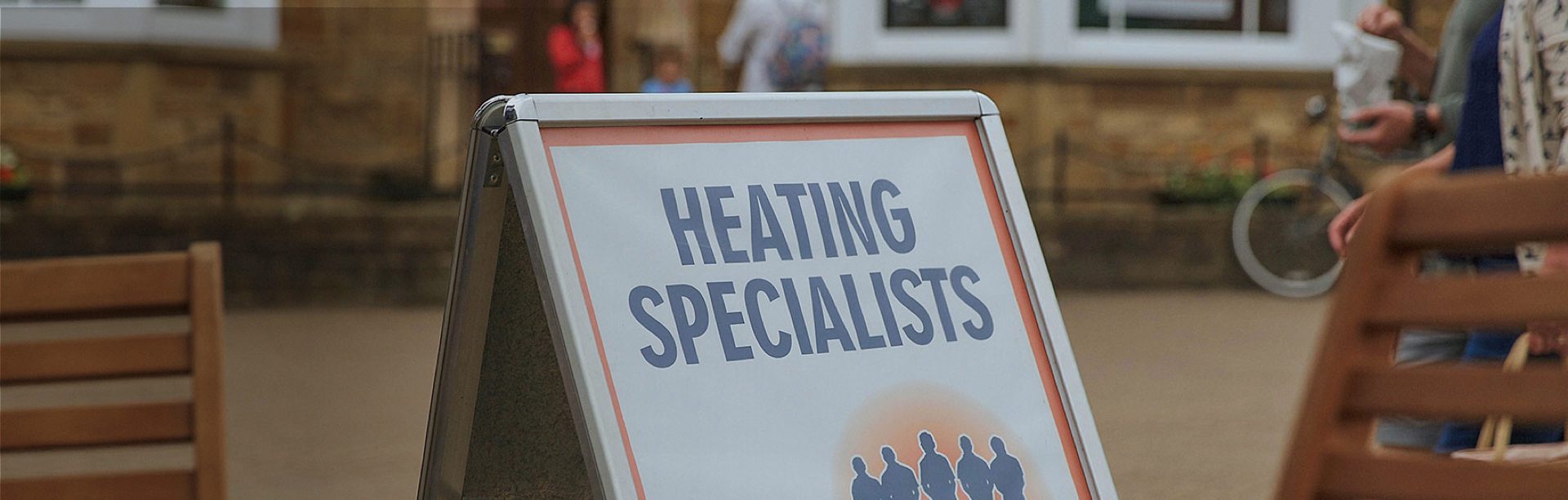A sign displaying the text Heating Specialists prominently, indicating a business focused on heating services.