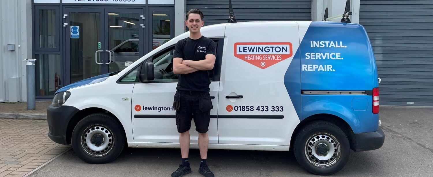 Lewington Heating technician standing beside a branded service van, ready for gas and oil heating installation, service, and repair work.